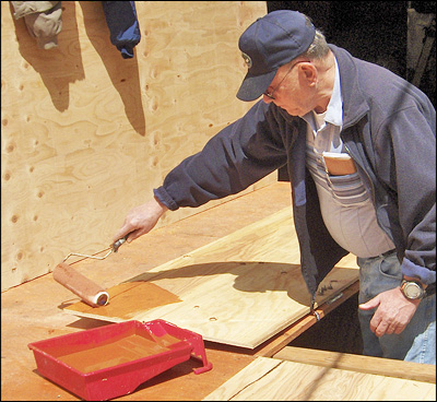 Chuck Kentfield Rolls On the Wood Preservative