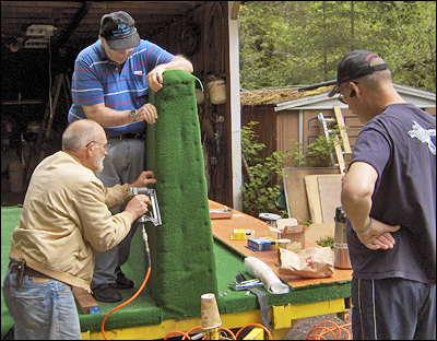 Burt Daggett, Dick Robb, and Bob Beatty Staple the Carpet