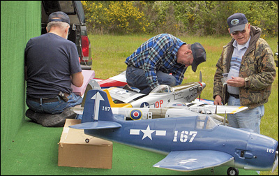 Burt Daggett, Bob Treinen, and Chuck Kentfield Position the Aircraft
